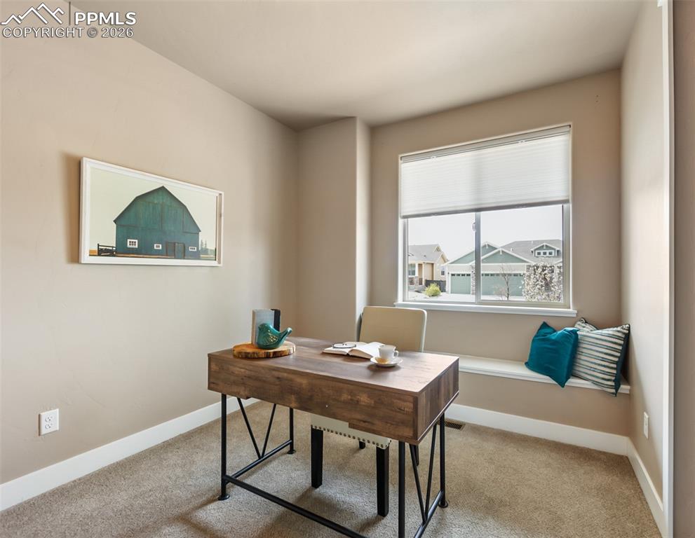 Image 22 of 50: Room with neutral beige wall paint and tan carpeting
