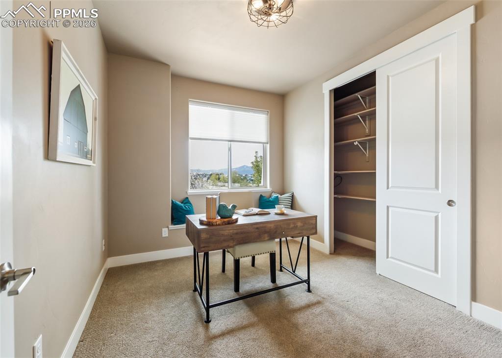 Image 23 of 50: Room featuring neutral wall tones, carpeted flooring, a window with an inte