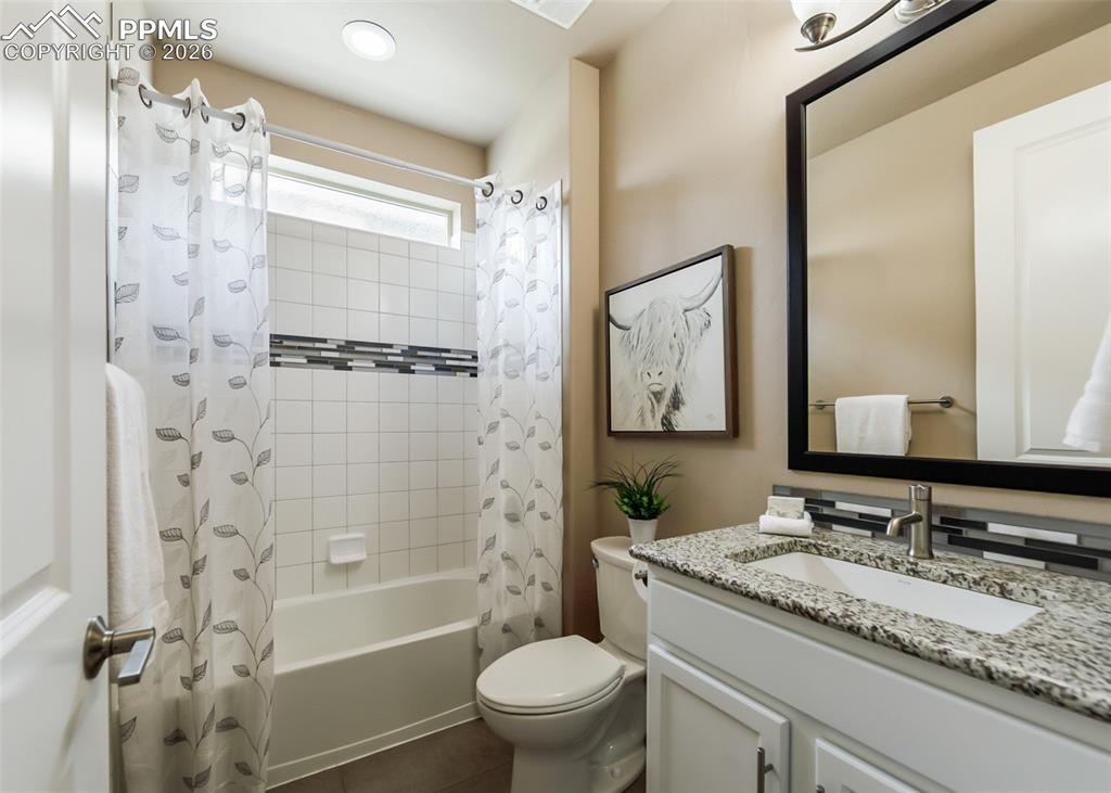Image 25 of 50: Bathroom featuring a white subway tile tub surround with a decorative accen