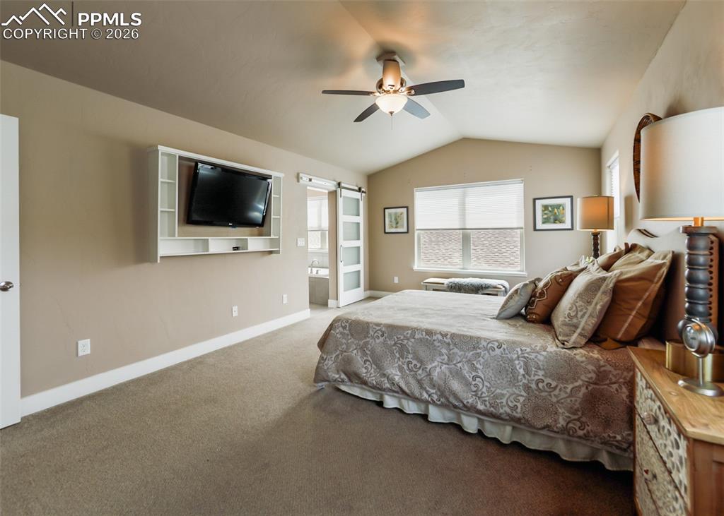 Image 35 of 50: Vaulted ceiling bedroom with neutral-toned walls