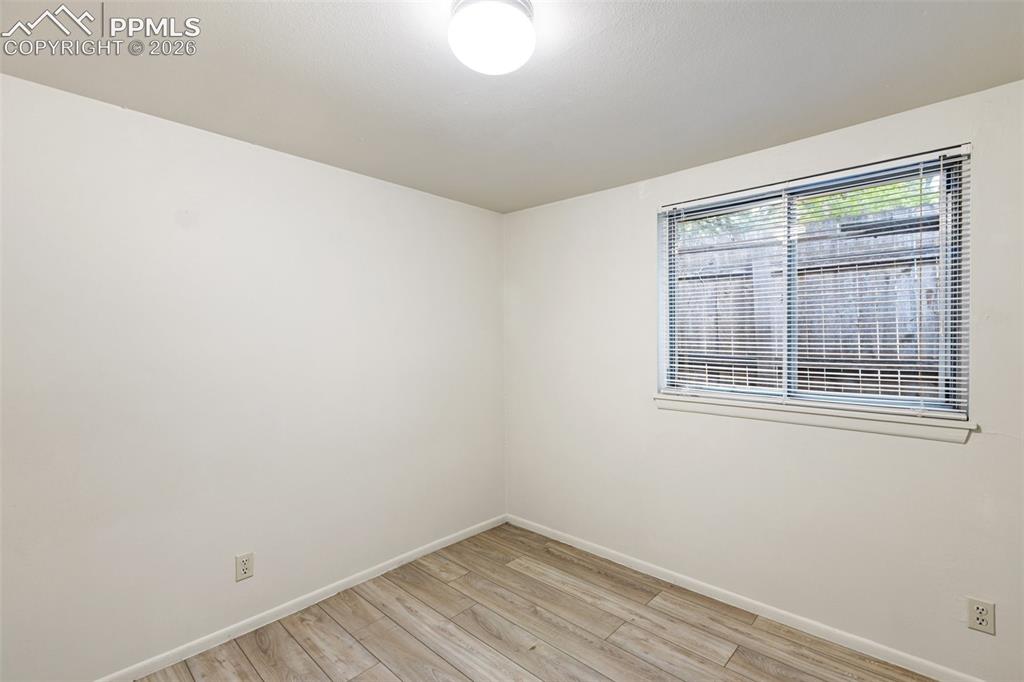 Image 19 of 35: One of 2 bedrooms - features LVP flooring for easy maintenance.