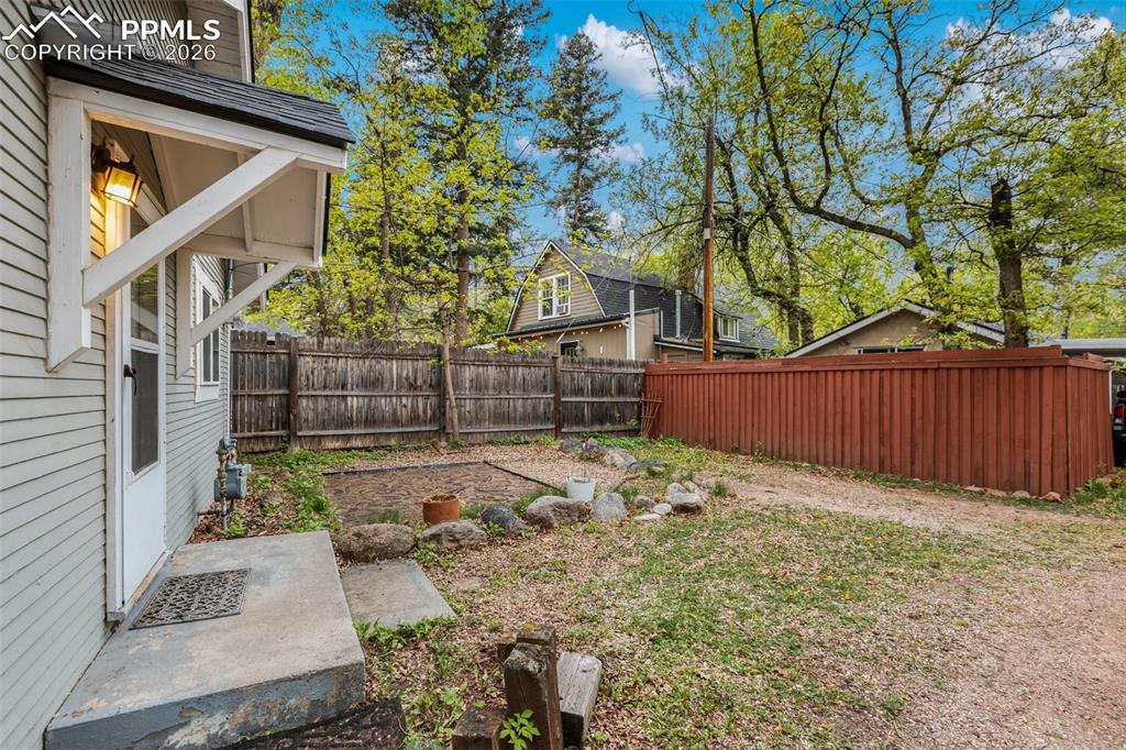 Image 5 of 34: This cottage home includes this yard area that would be an ideal patio and 