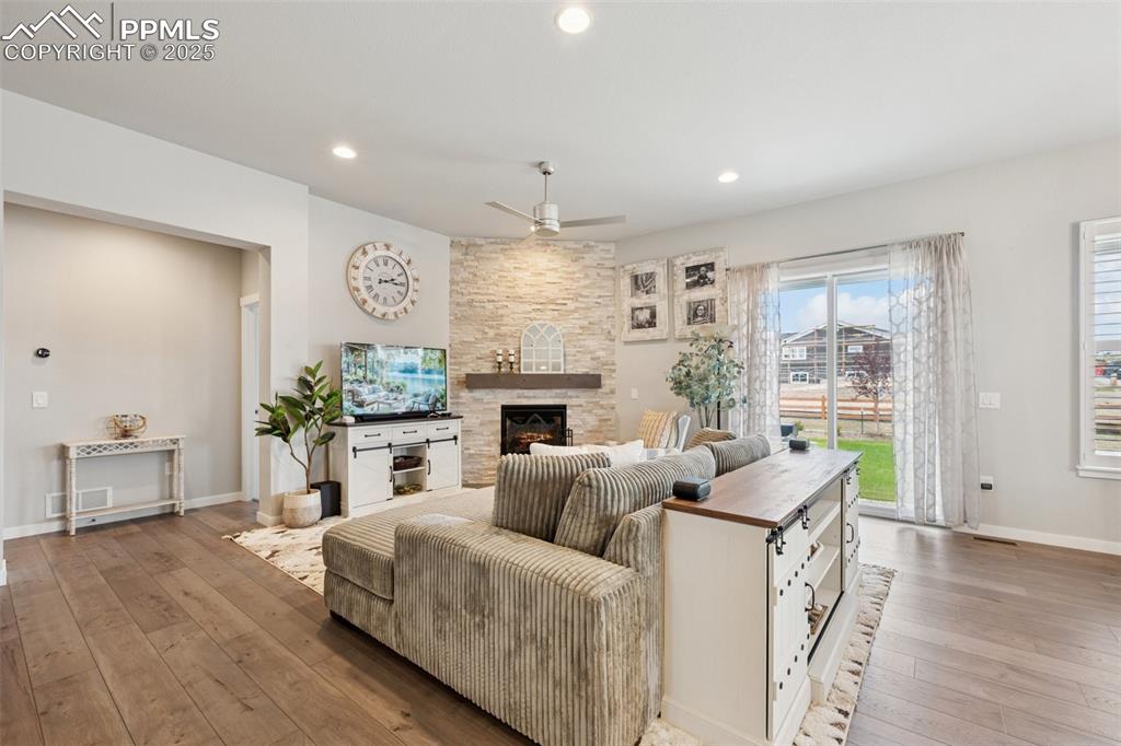 Image 16 of 45: Full height stone fireplace and walk out to large back yard!