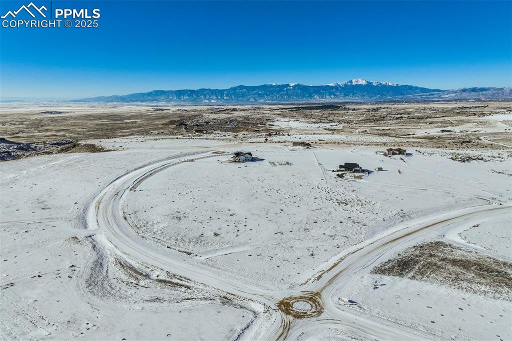 Image 15 of 20: Snowy aerial view featuring a mountain view