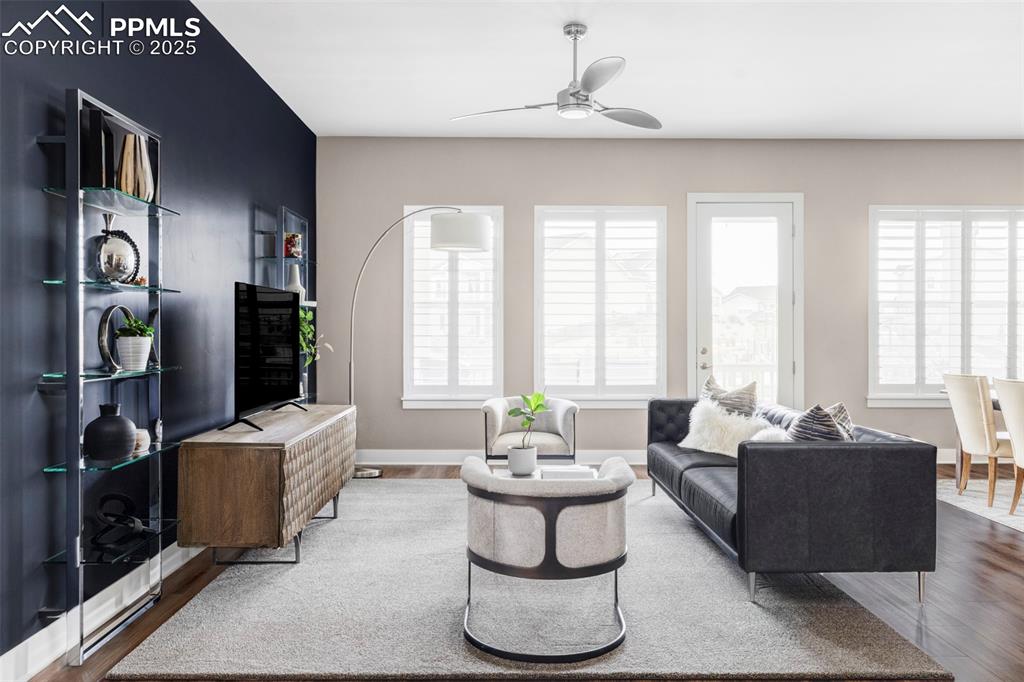 Image 14 of 44: Living area with wood finished floors, plenty of natural light, and ceiling