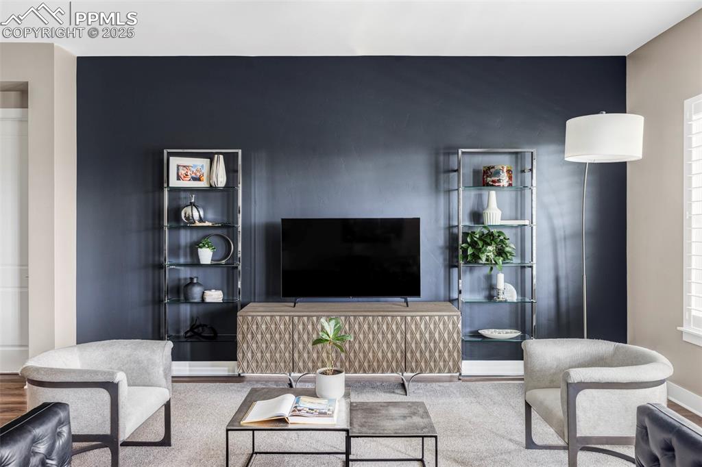 Image 15 of 44: Living room featuring baseboards and wood finished floors