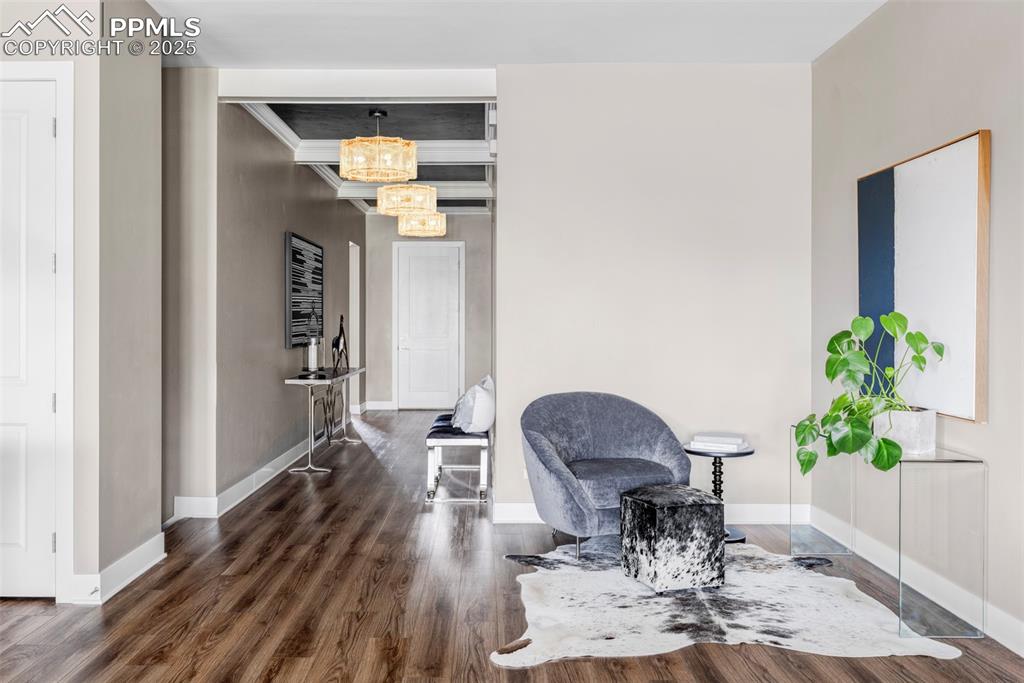 Image 17 of 44: Living area featuring dark wood finished floors and a chandelier