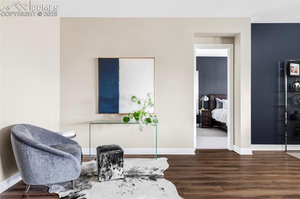 Image 18 of 44: Sitting room with baseboards and dark wood finished floors