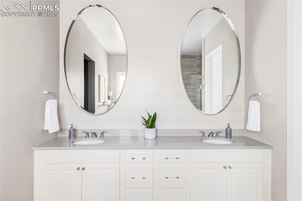 Image 24 of 44: Bathroom featuring double vanity