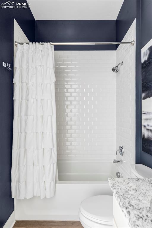 Image 31 of 44: Full bath with shower /bathtub combination with curtain, vanity, and wood f