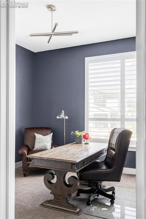 Image 32 of 44: Carpeted office space featuring baseboards