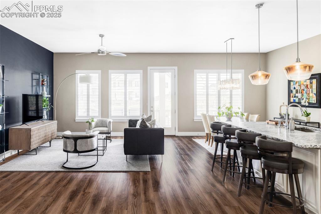 Image 5 of 44: Living area with healthy amount of natural light, dark wood-type flooring, 