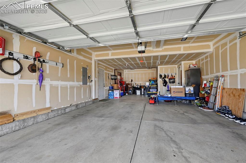 Image 38 of 44: Three-car tandem garage with an exterior access door.