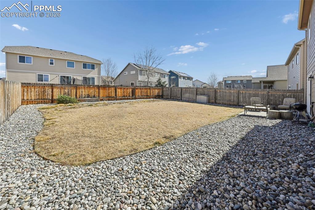 Image 40 of 44: Spacious fenced in backyard.