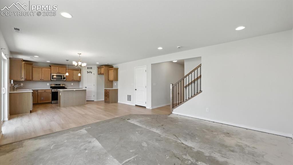 Image 12 of 50: View of the Dining Area and Kitchen from the Living Room.