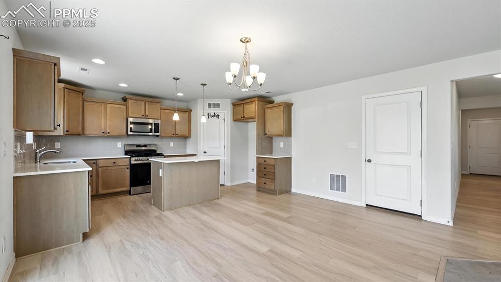 Image 13 of 50: Dining Area and Island Kitchen,
