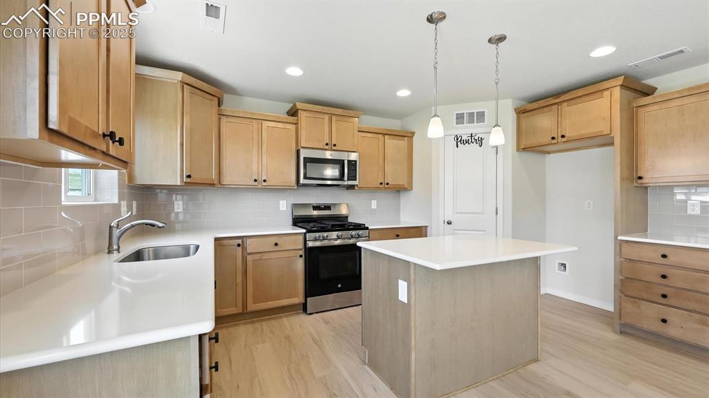 Image 15 of 50: The Kitchen is a delight with quartz countertops, subway tile backsplash, p