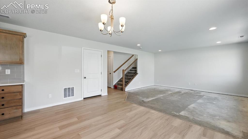 Image 21 of 50: View of the Dining Area, Living Room, and stairs to the upper level.