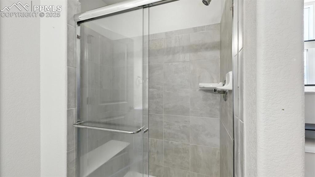 Image 35 of 50: Enclosed tiled shower in the Primary Bathroom.
