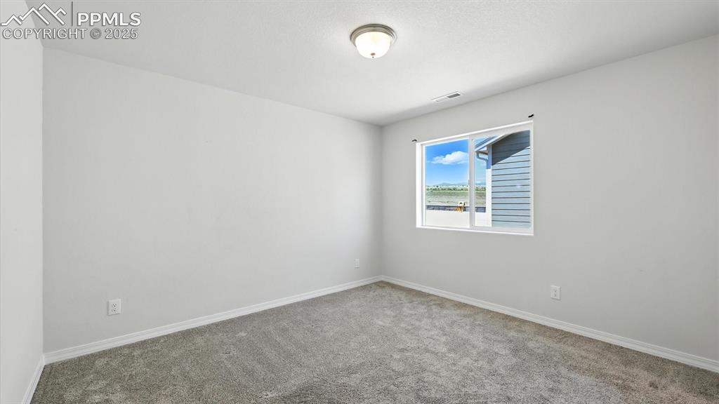 Image 43 of 50: Upper Level Bedroom #3 with neutral carpet.