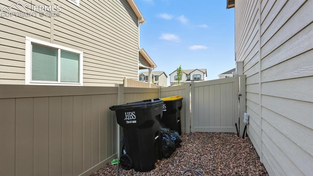 Image 48 of 50: Side yard with gate to the front yard.
