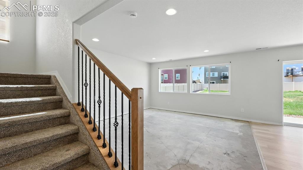 Image 9 of 50: Living Room with views to the backyard (needs new flooring).