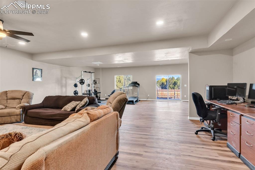 Image 24 of 37: Access to the fully landscaped and fenced back yard from this space