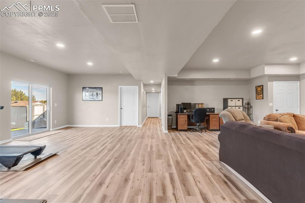 Image 28 of 37: Living room featuring an office area, light wood-type flooring, and recesse