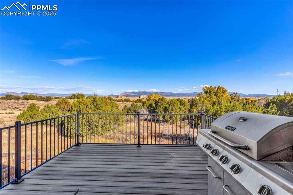 Image 33 of 37: Trex deck offering mountain views is great for entertaining or enjoying the