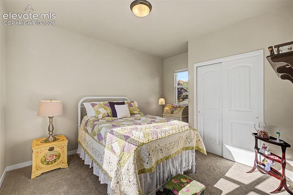 Image 10 of 45: Private secondary main-level bedroom conveniently located adjacent to a ful