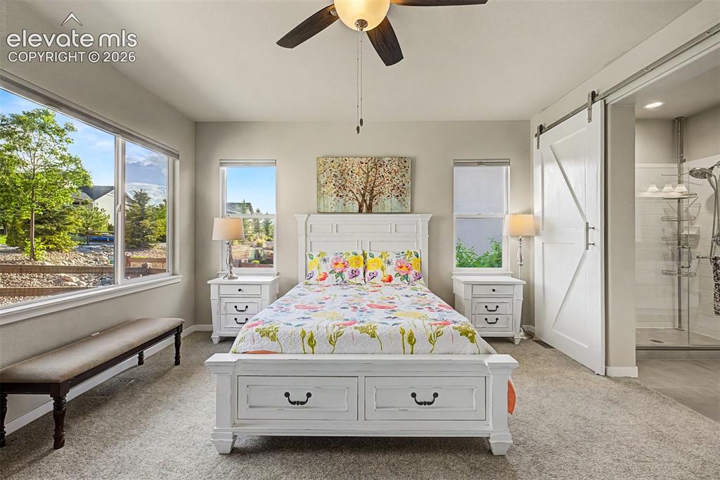 Image 23 of 45: Spacious primary suite offers a serene main-level retreat with abundant nat