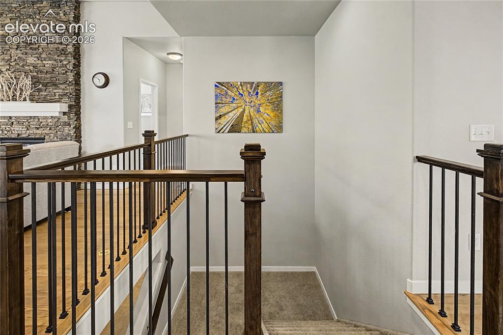 Image 28 of 45: Open staircase with contemporary railings adds architectural interest and m