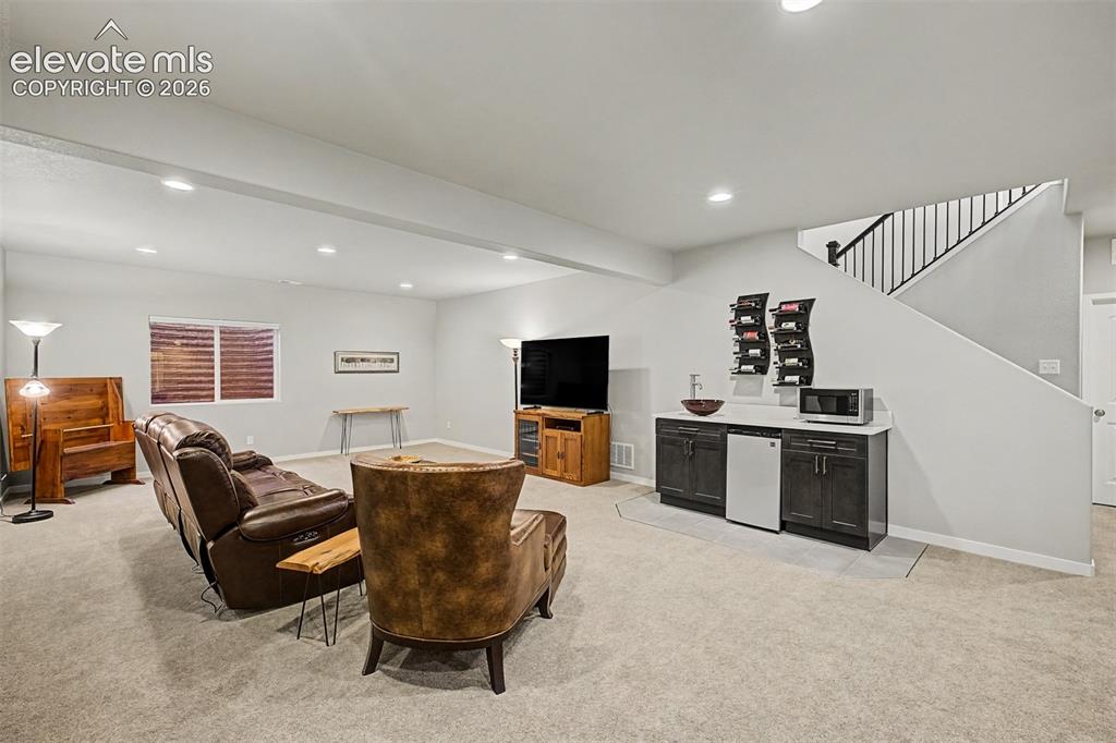 Image 30 of 45: Spacious basement family room offers a comfortable second living area with 