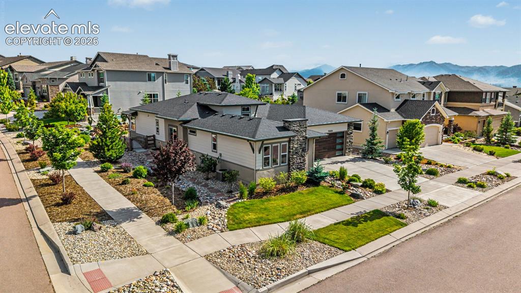 Image 44 of 45: Single-story property featuring a stone and stucco exterior, an attached tw