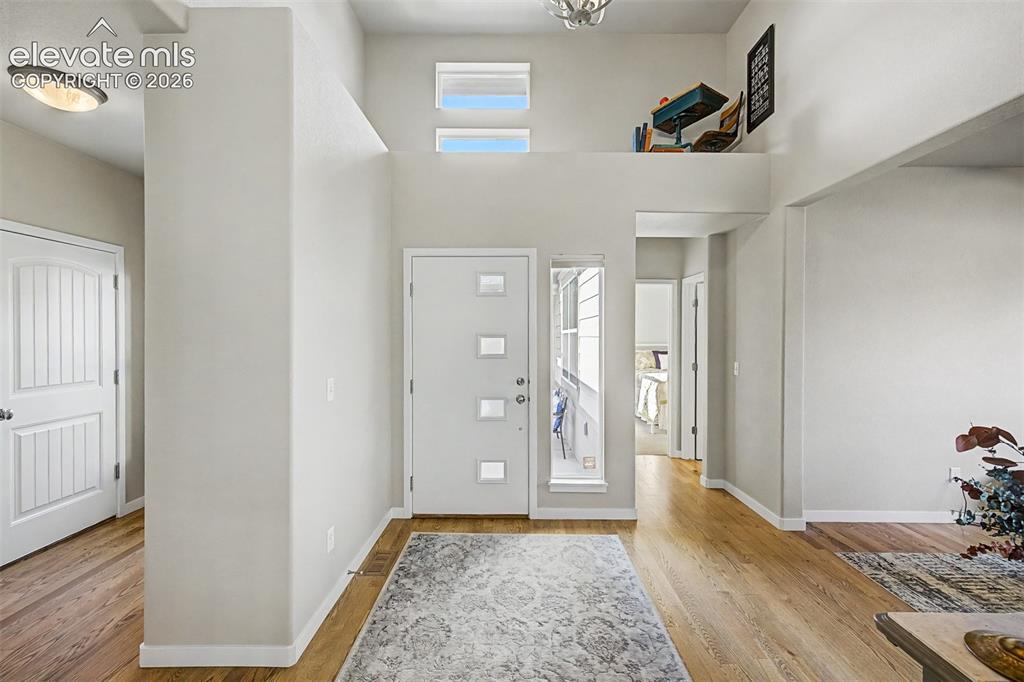 Image 5 of 45: A bright and welcoming entry with soaring ceilings and abundant natural lig