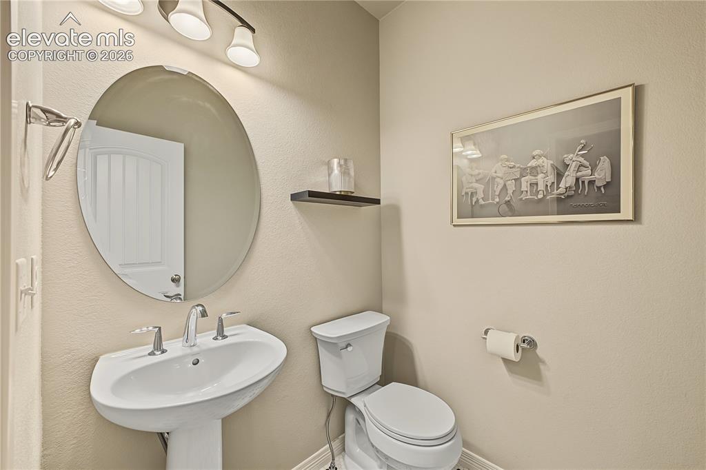 Image 9 of 45: Convenient powder room provides a dedicated space for guests without the ne