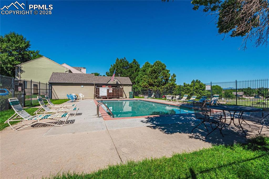 Image 35 of 36: Community pool with a patio