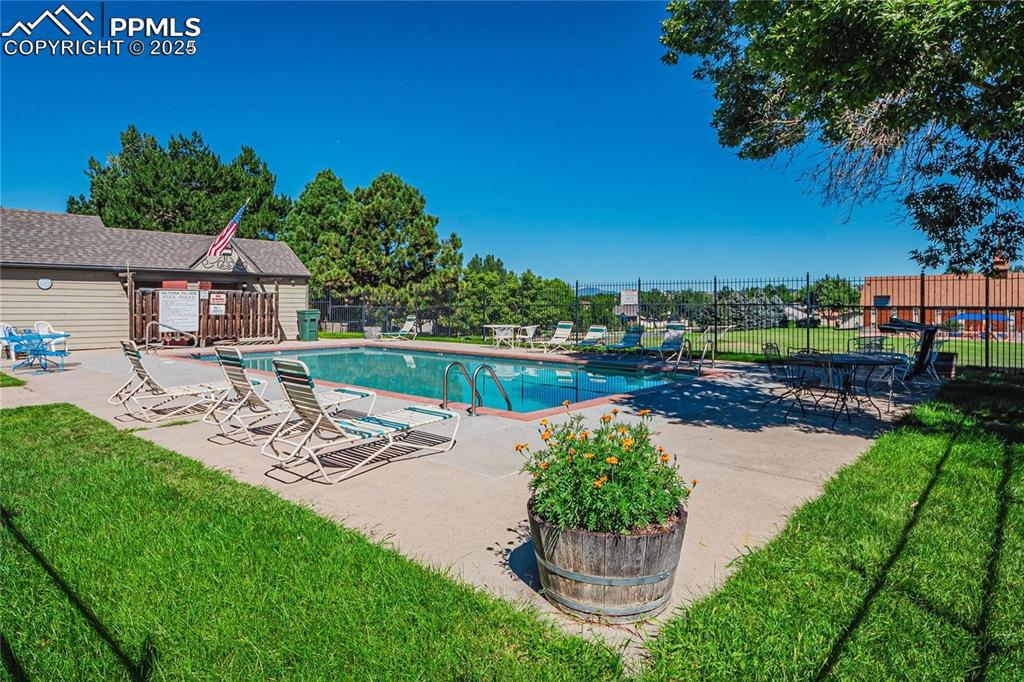 Image 36 of 36: Community pool featuring a patio area
