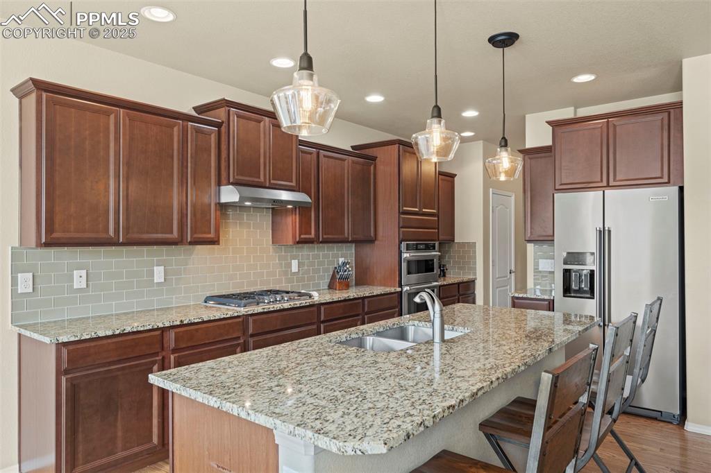 Image 14 of 44: Kitchen with appliances with stainless steel finishes, a sink, under cabine