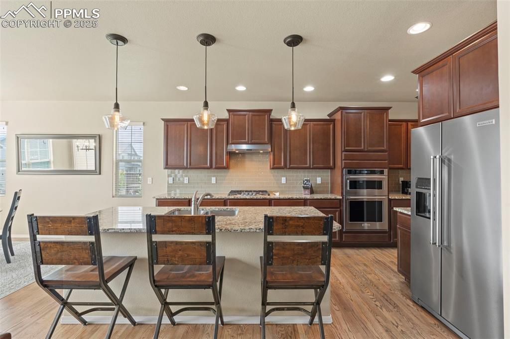Image 15 of 44: Kitchen with appliances with stainless steel finishes, a sink, under cabine