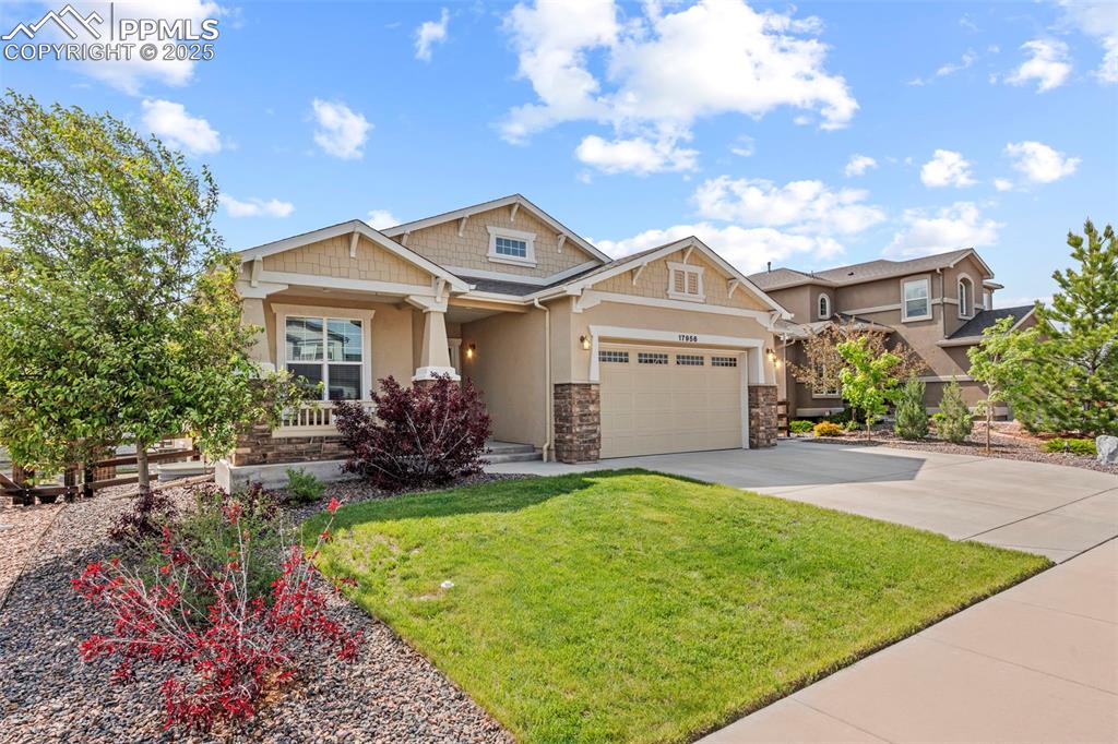 Image 2 of 44: Craftsman inspired home featuring stucco siding, stone siding, covered porc