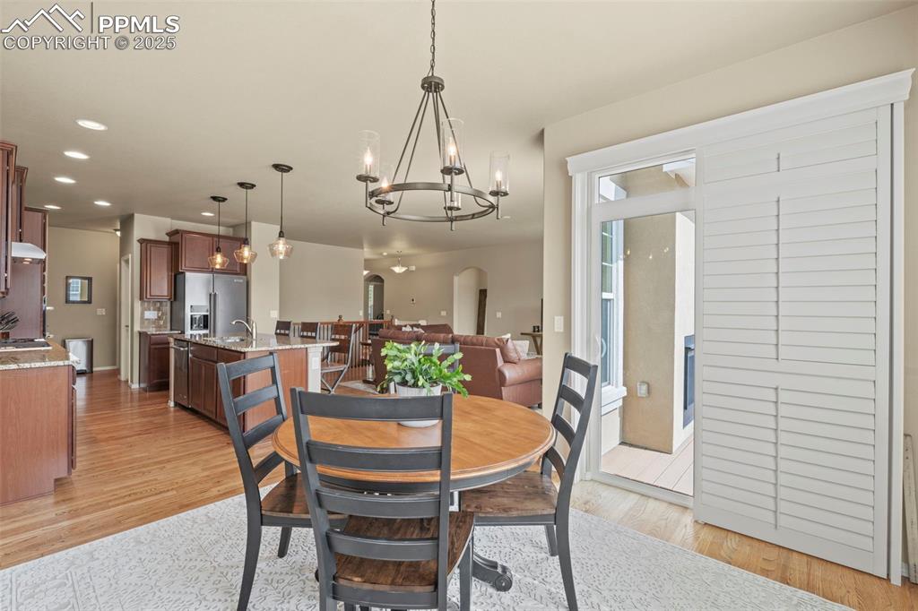 Image 21 of 44: Dining area featuring a chandelier, light wood-type flooring, recessed ligh
