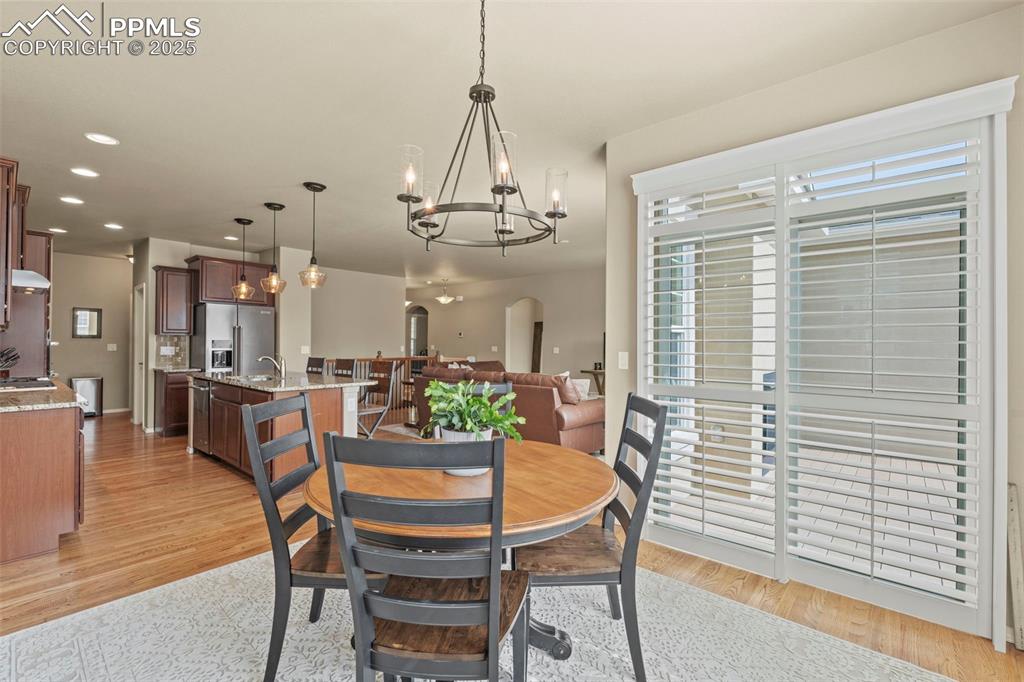 Image 22 of 44: Dining space featuring a chandelier, light wood-style floors, and recessed 