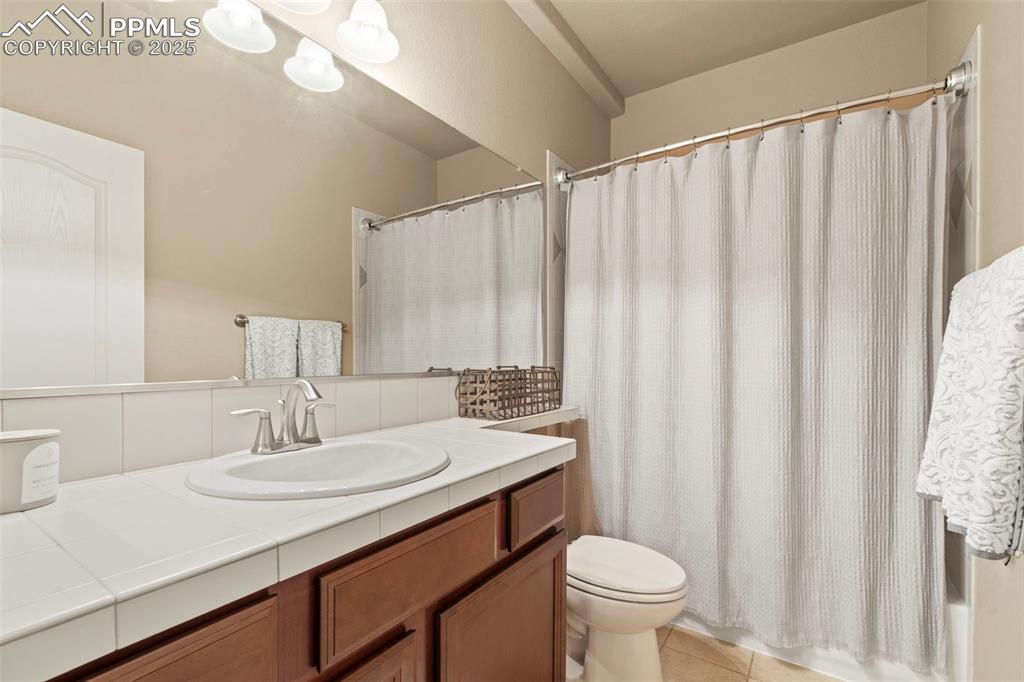 Image 32 of 44: Bathroom featuring toilet, vanity, and tile patterned floors