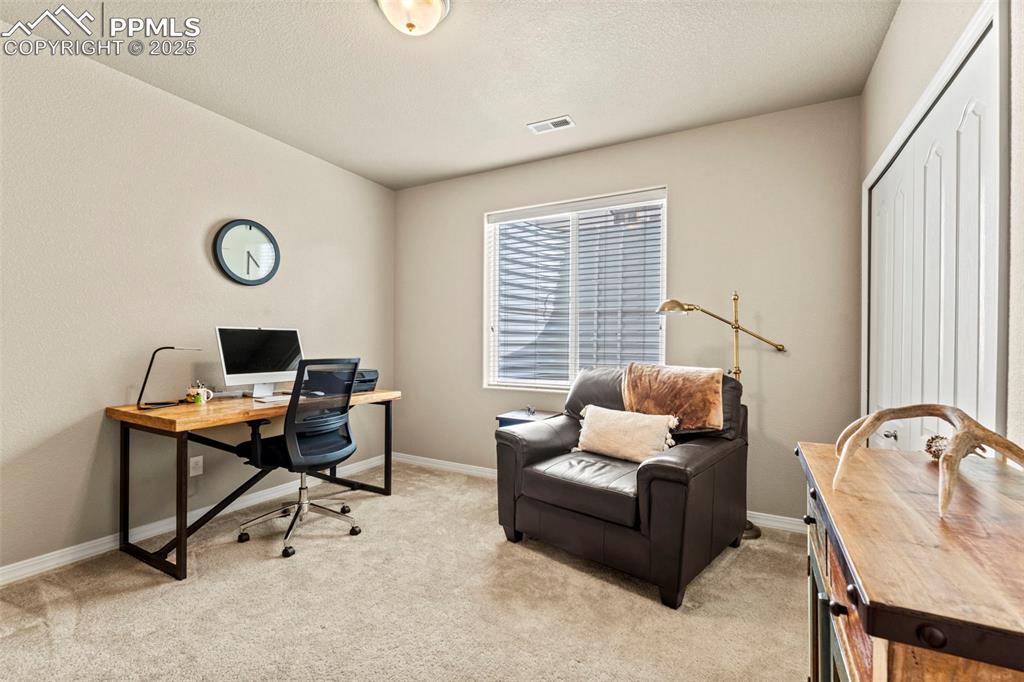 Image 37 of 44: Office area with light carpet and baseboards