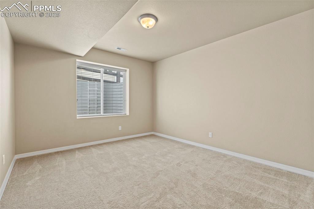 Image 40 of 44: Spare room with light colored carpet and baseboards