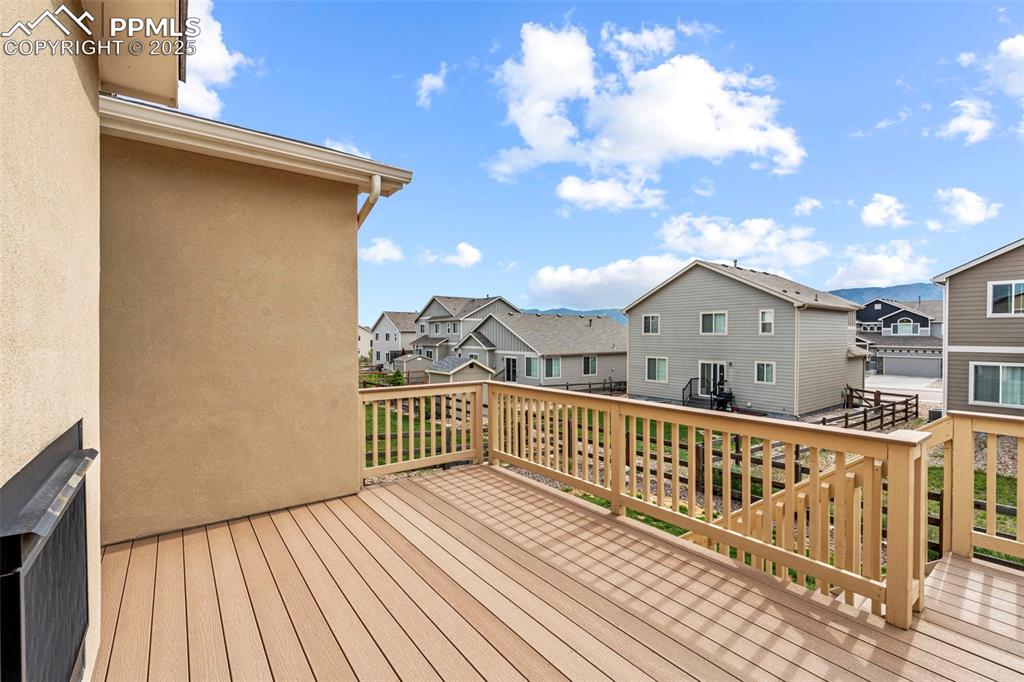 Image 41 of 44: Wooden terrace with a residential view