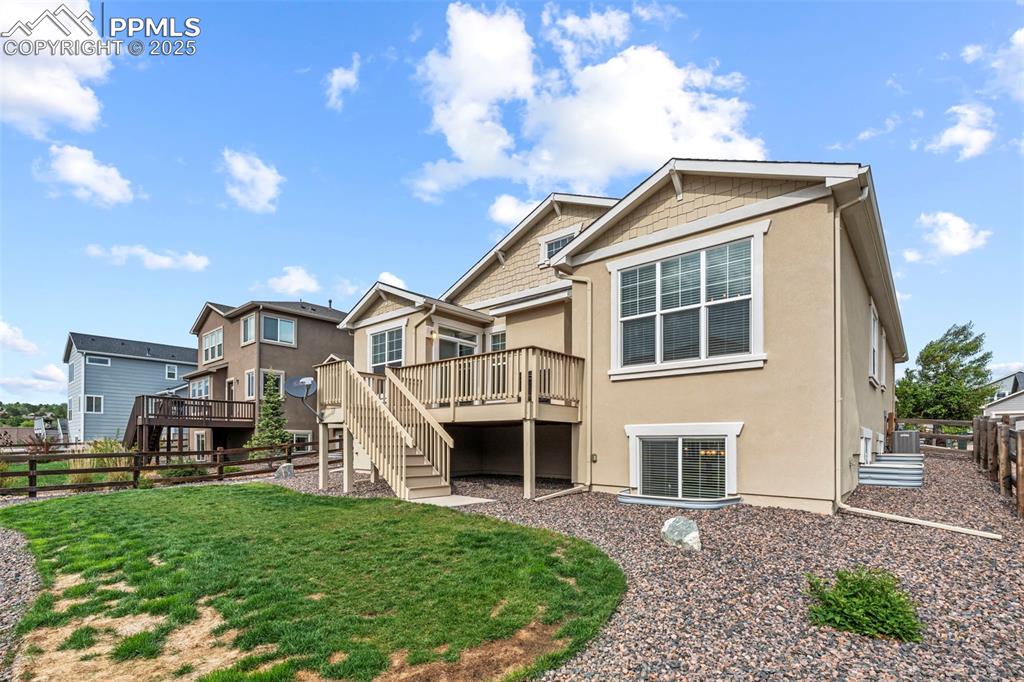 Image 43 of 44: Rear view of house with cooling unit, a deck, stairs, and stucco siding