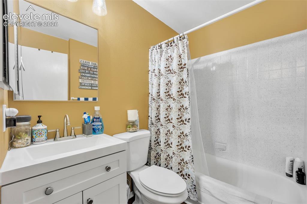 Image 8 of 13: Full bathroom with vanity and shower / bath combination with curtain
