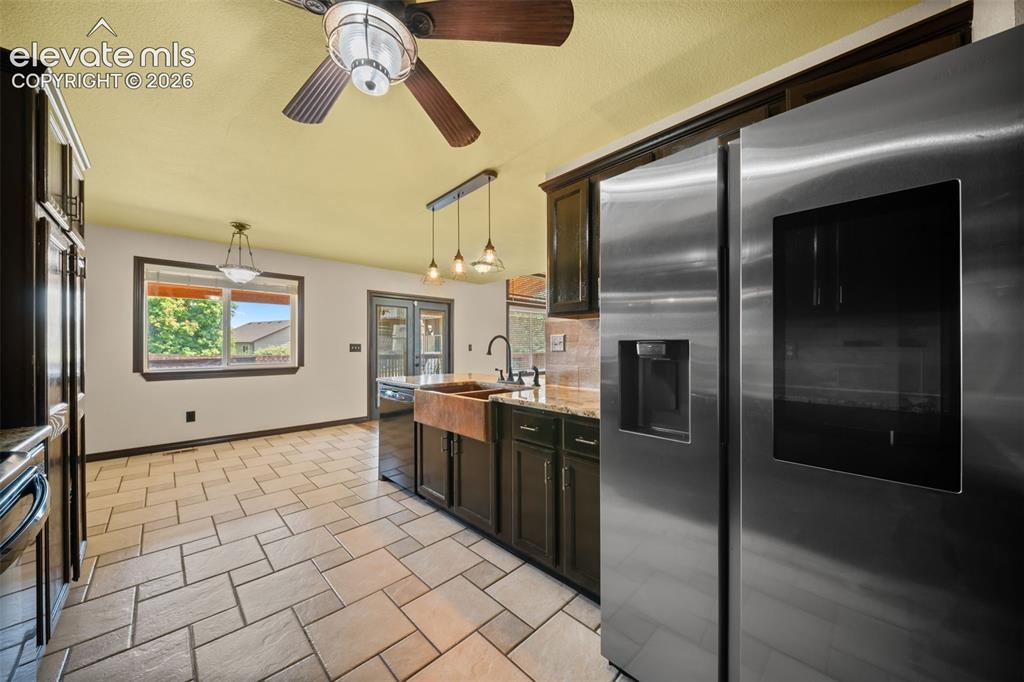 Image 13 of 48: Stainless steel side-by-side refrigerator, dark wood-finish cabinetry, copp